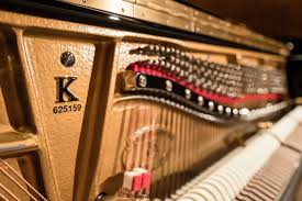 Close-up of piano strings and hammers.