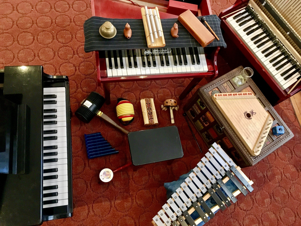 Various musical instruments arranged on patterned carpet.
