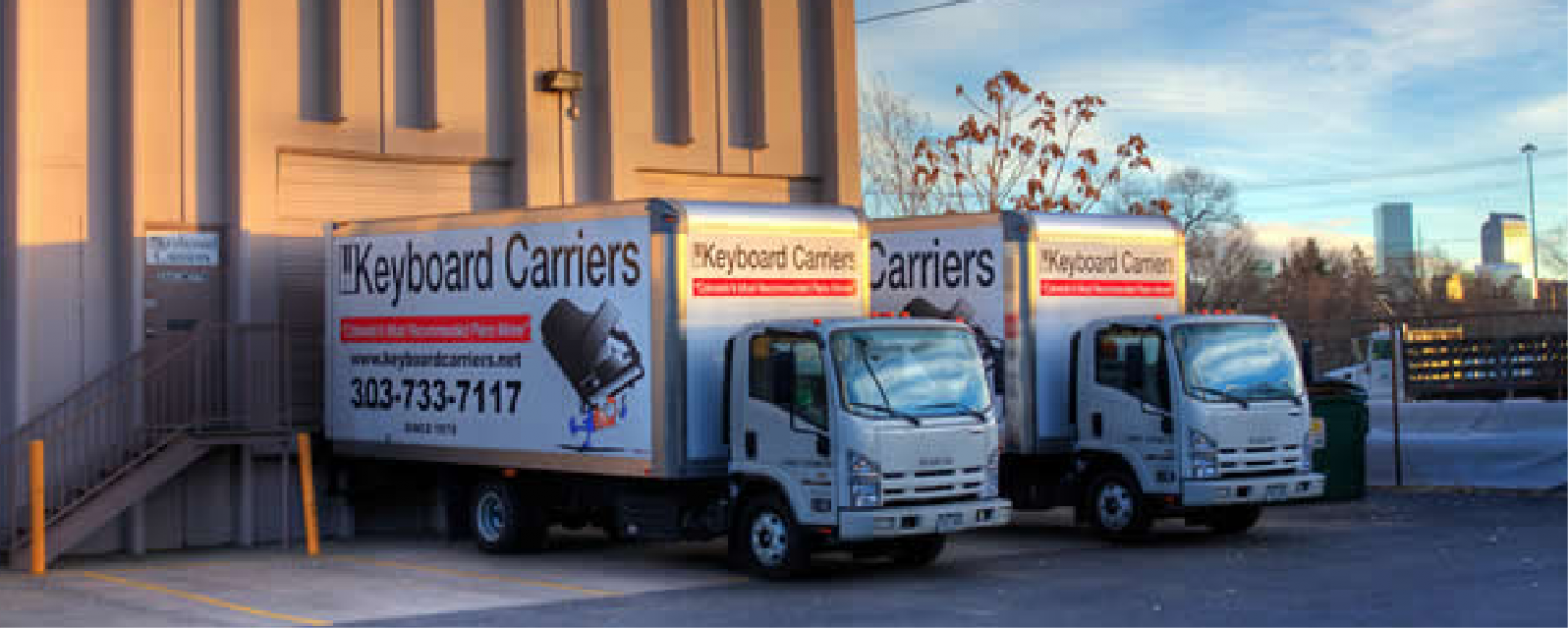 Delivery trucks with colorful keyboard-themed advertisements parked in a row.