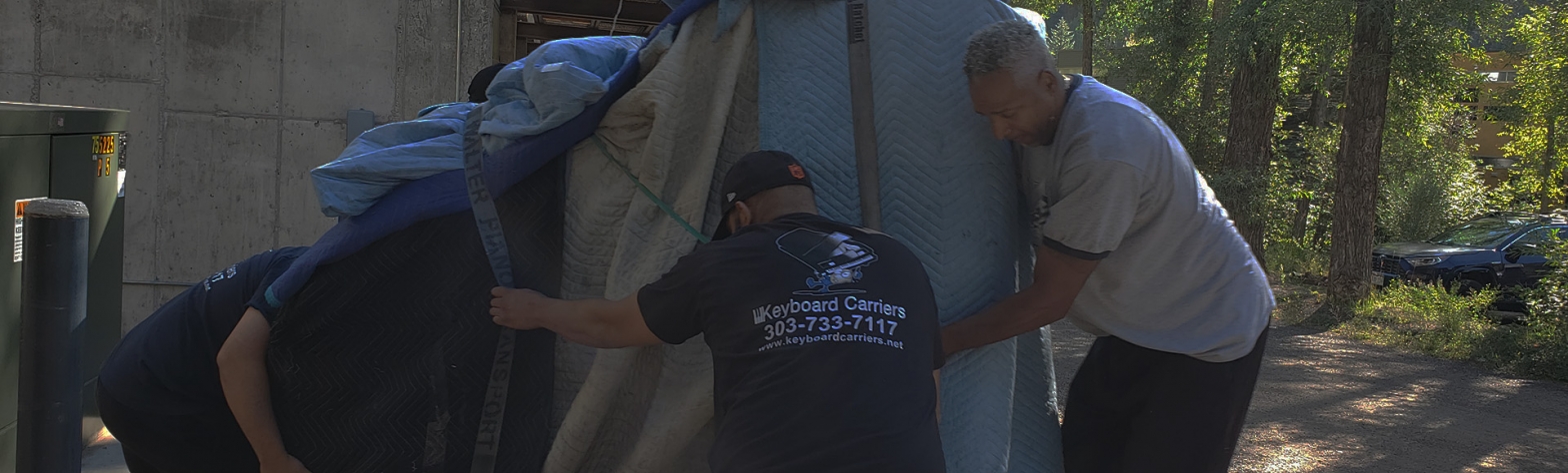 Two men working together to set up a large tent.