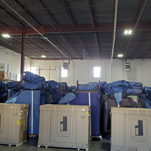 Warehouse with stacked furniture and crates.