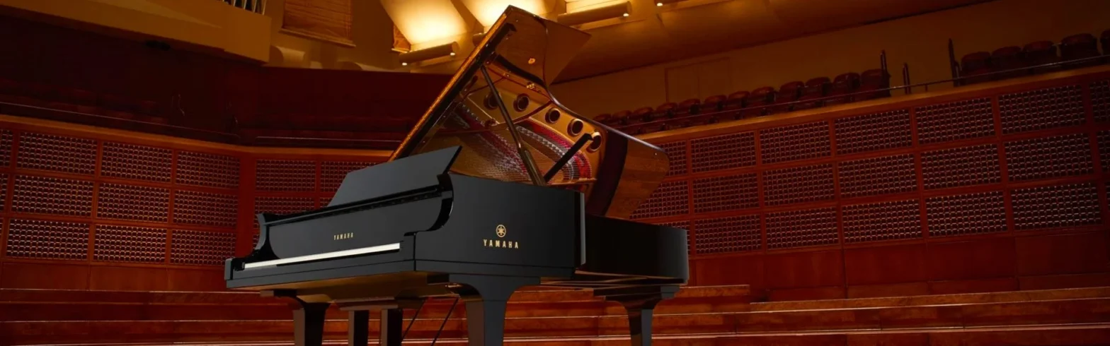 Grand piano on concert hall stage.
