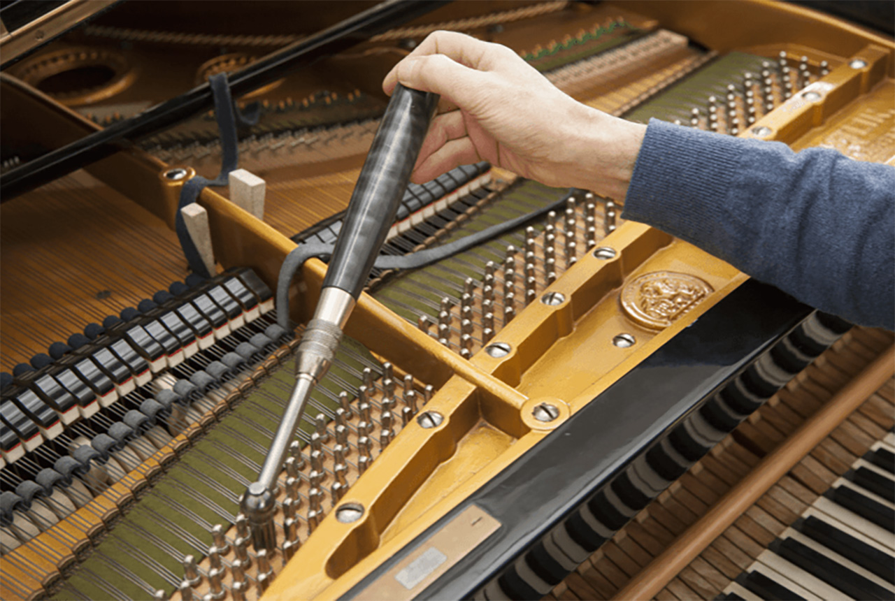 Piano tuning with a tuning lever tool.