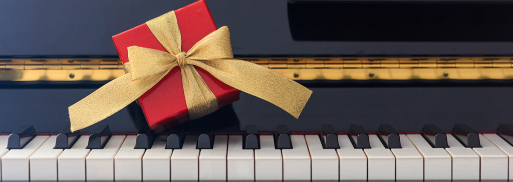 Red gift box on piano keys.