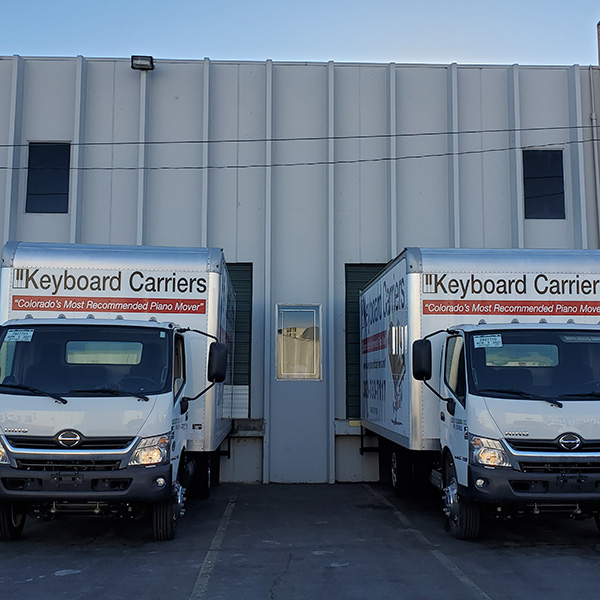 Two trucks parked outside a building.