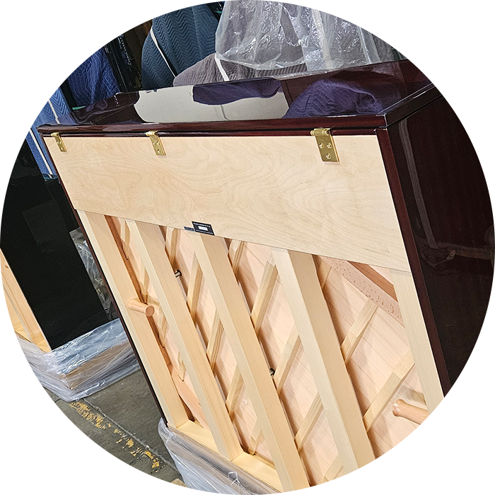 Upright piano back with intricate wood design.