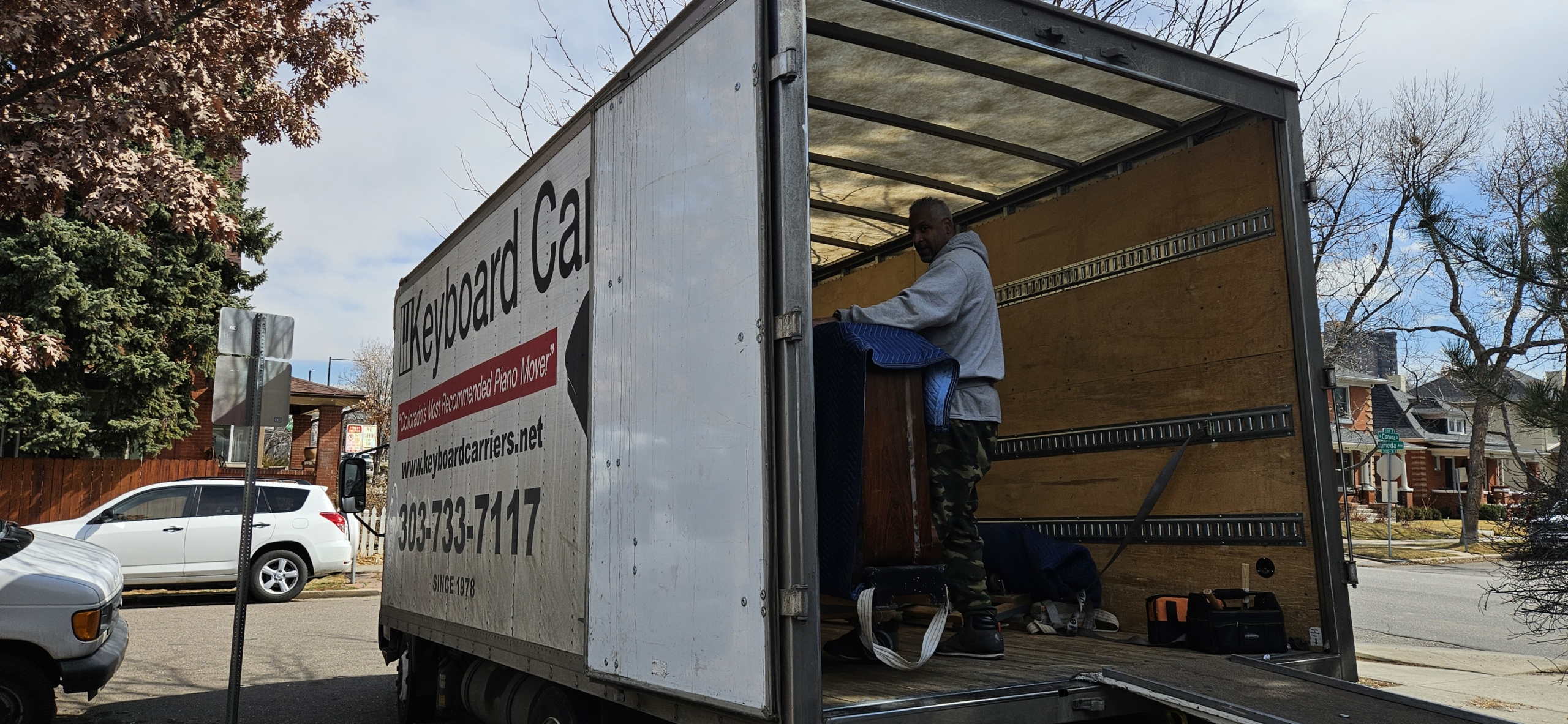 Man loading items into a moving truck.