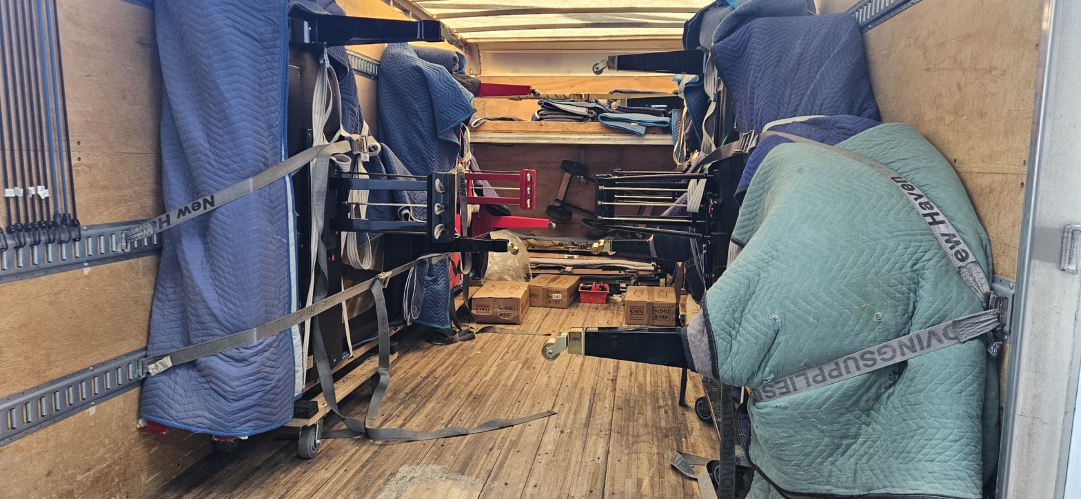 Moving truck interior with secured furniture items.